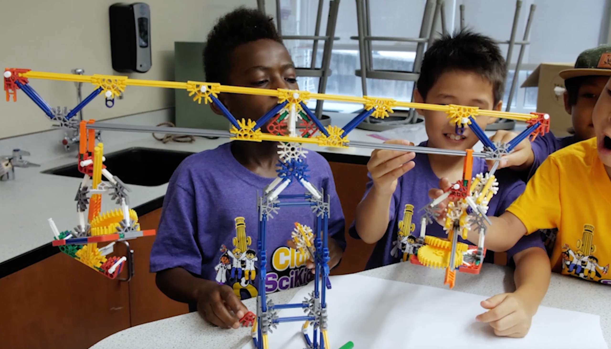 Three boys building a contraption in one of our engineering STEM summer camps.